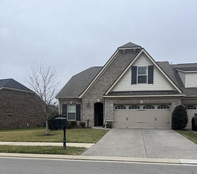 view of front facade with a garage and a front lawn