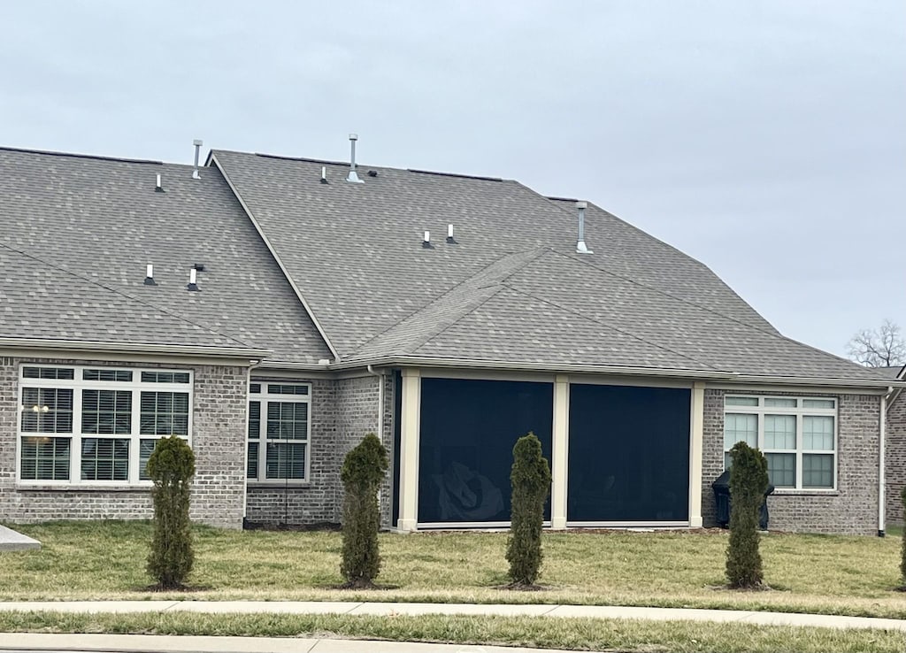 rear view of property featuring a yard