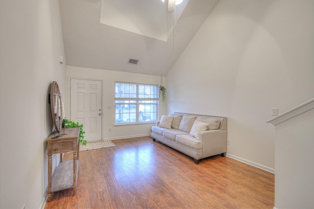 living room featuring ceiling fan, high vaulted ceiling, and hardwood / wood-style floors