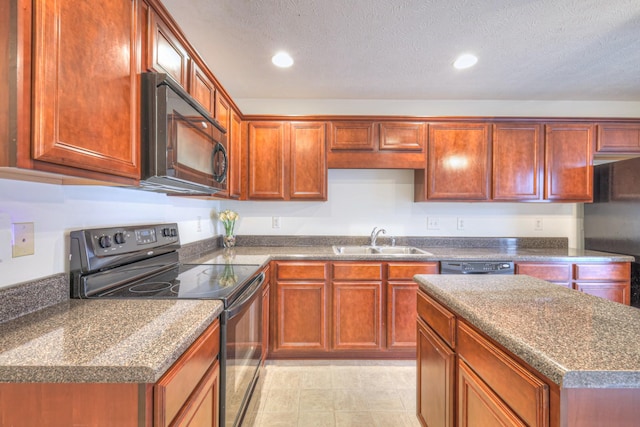 kitchen with sink, dark stone counters, a textured ceiling, and black appliances