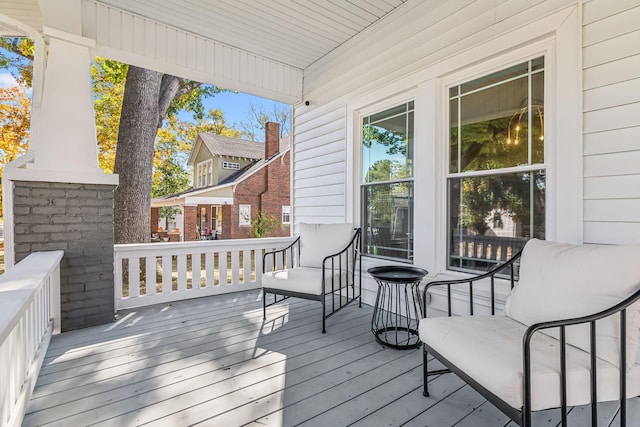 wooden terrace featuring covered porch