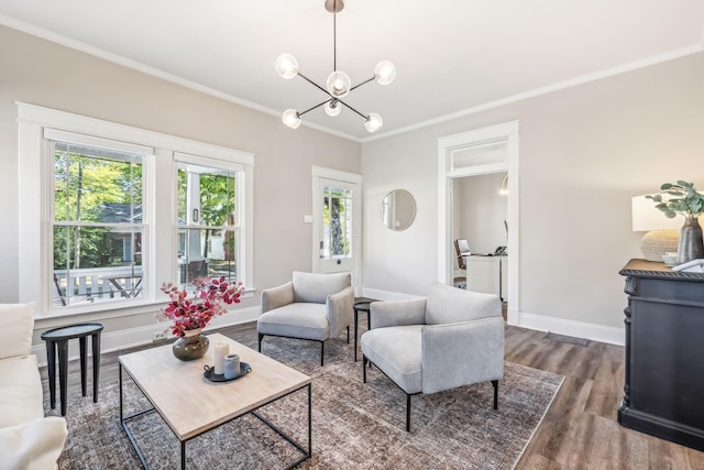 living room with crown molding, dark hardwood / wood-style floors, and a notable chandelier