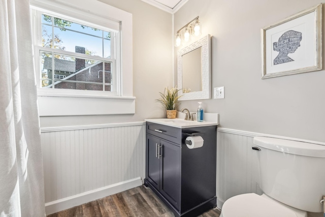 bathroom with vanity, toilet, and hardwood / wood-style floors