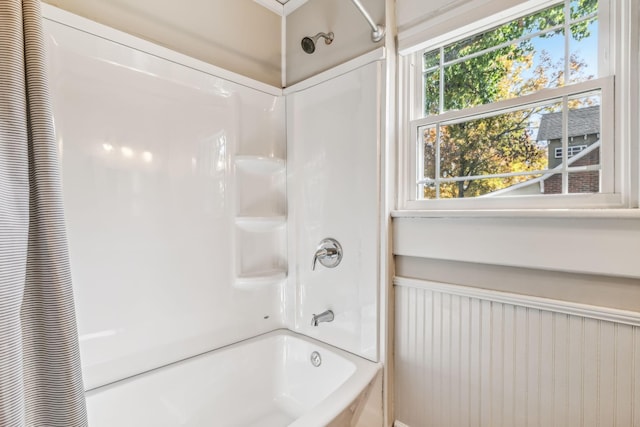 bathroom with shower / bath combo with shower curtain