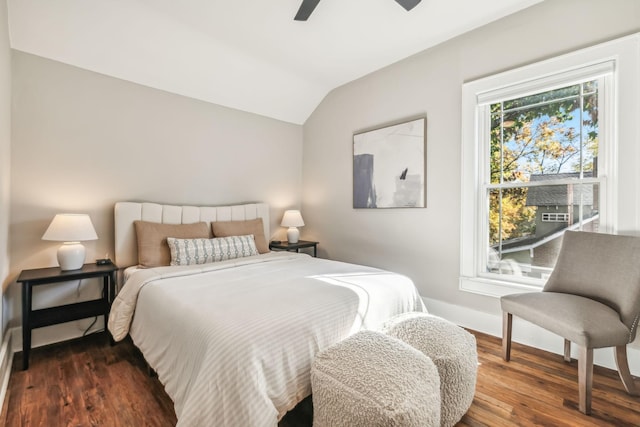 bedroom featuring ceiling fan, lofted ceiling, and dark hardwood / wood-style flooring