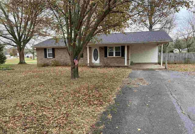 ranch-style home featuring a carport