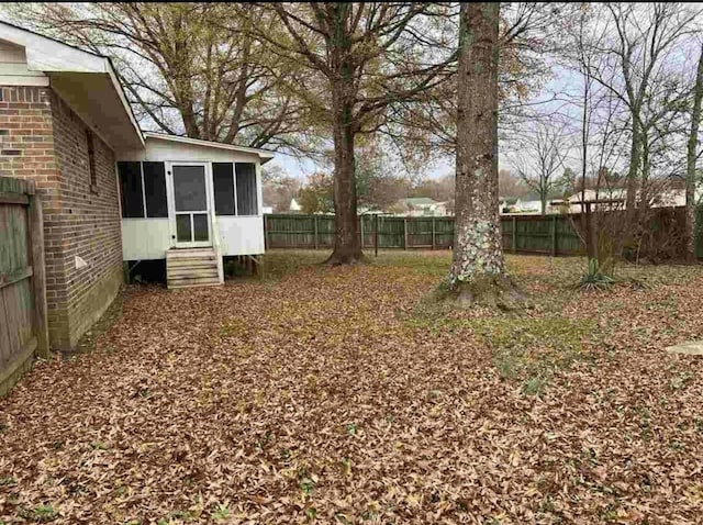 view of yard with a sunroom