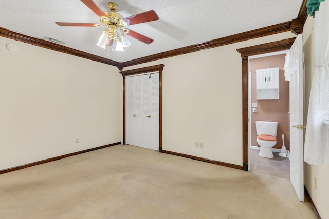 unfurnished bedroom with ornamental molding, light carpet, and a textured ceiling