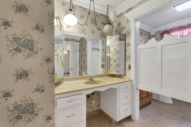 bathroom with ornamental molding, a textured ceiling, and vanity