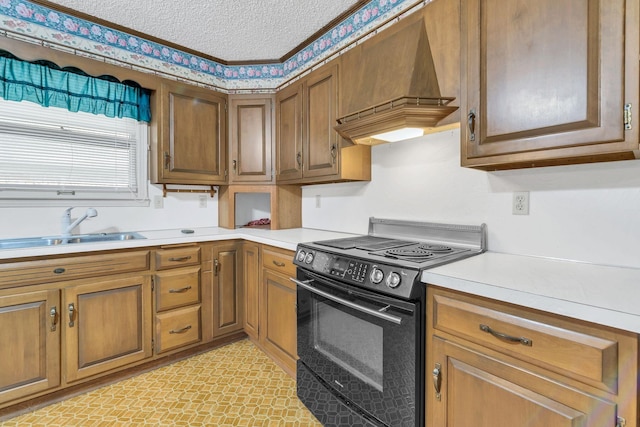 kitchen with premium range hood, black electric range oven, sink, and a textured ceiling