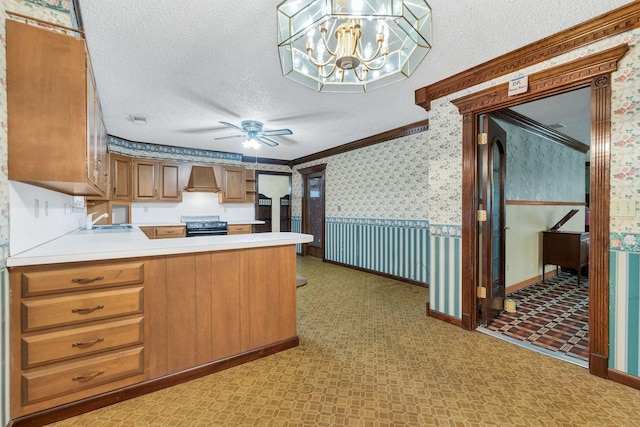 kitchen with black stove, sink, crown molding, a textured ceiling, and kitchen peninsula