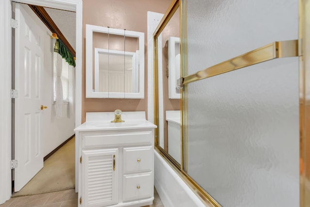 bathroom featuring enclosed tub / shower combo and vanity