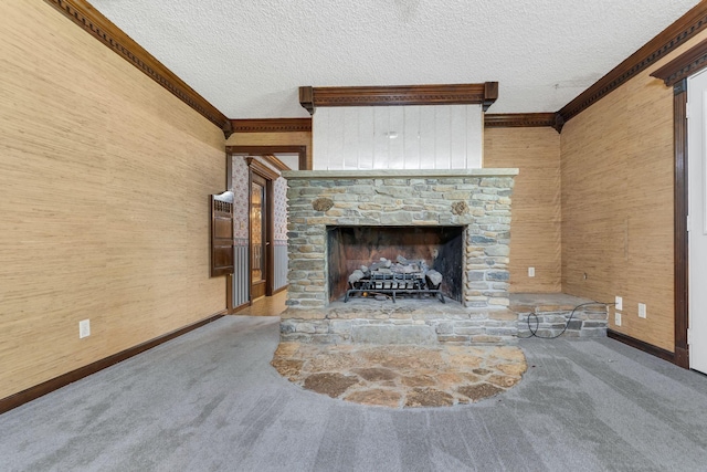 unfurnished living room featuring ornamental molding, a fireplace, carpet, and a textured ceiling