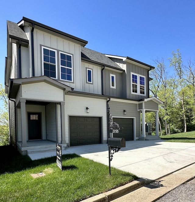 view of front of property featuring a garage and a front lawn