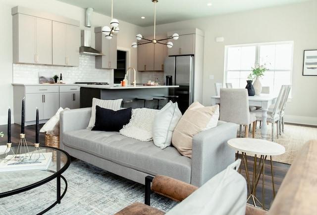 living room featuring sink and light hardwood / wood-style flooring