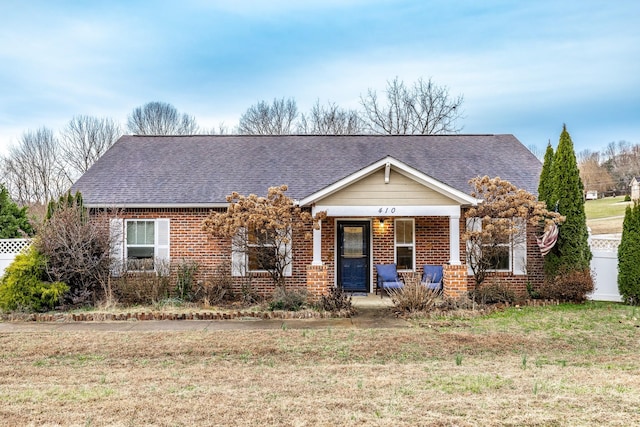 view of front of house featuring a porch and a front yard