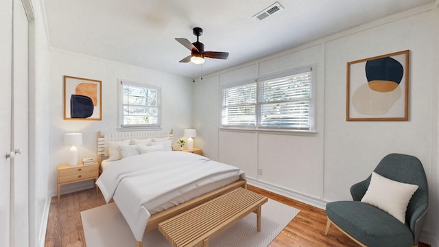 bedroom with ceiling fan and light hardwood / wood-style floors