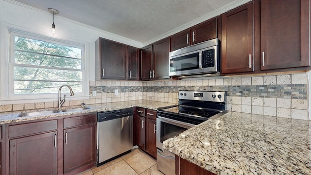 kitchen featuring appliances with stainless steel finishes, tasteful backsplash, sink, light tile patterned floors, and light stone countertops