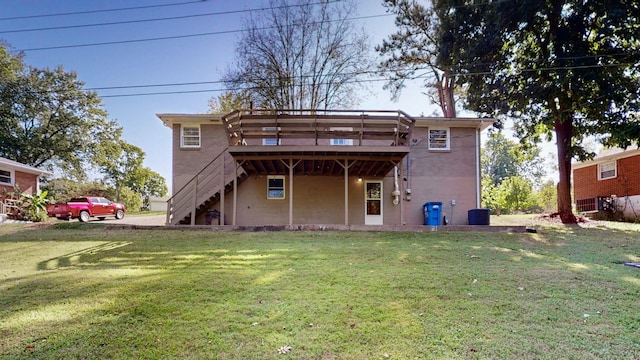 back of house with a deck, a lawn, and central air condition unit