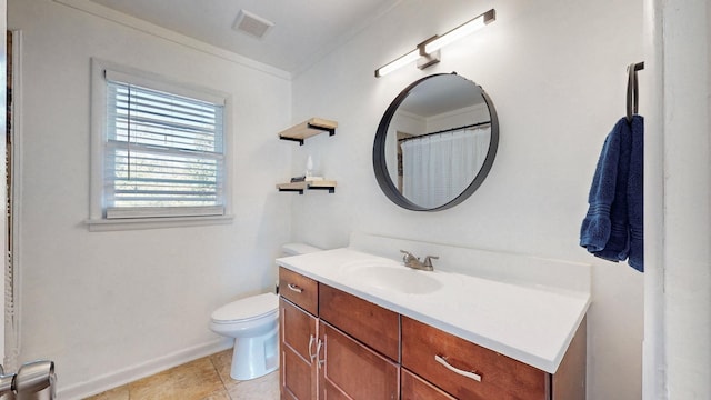 bathroom with vanity, tile patterned flooring, crown molding, and toilet