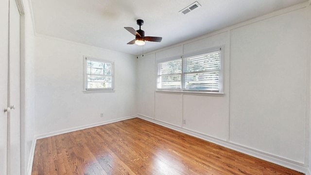 empty room with ceiling fan and wood-type flooring