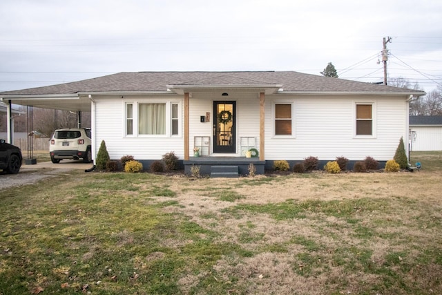 view of front facade with a carport and a front lawn