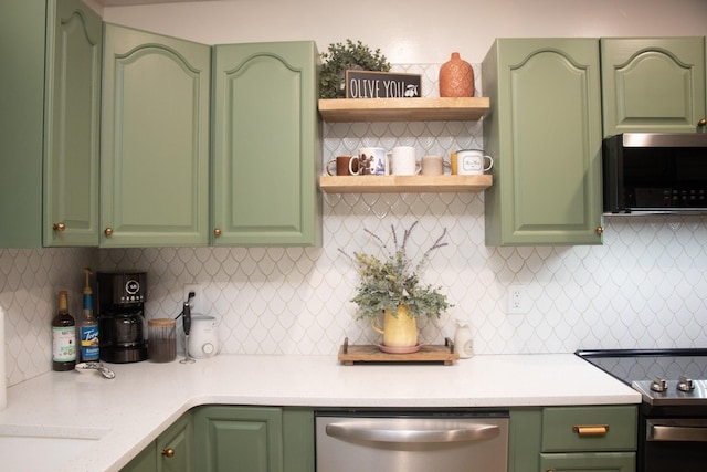 kitchen with appliances with stainless steel finishes, green cabinets, and backsplash