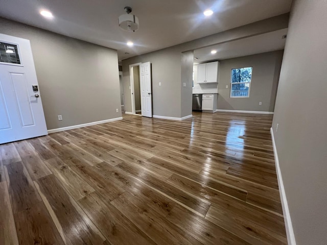 unfurnished living room featuring recessed lighting, baseboards, and wood finished floors