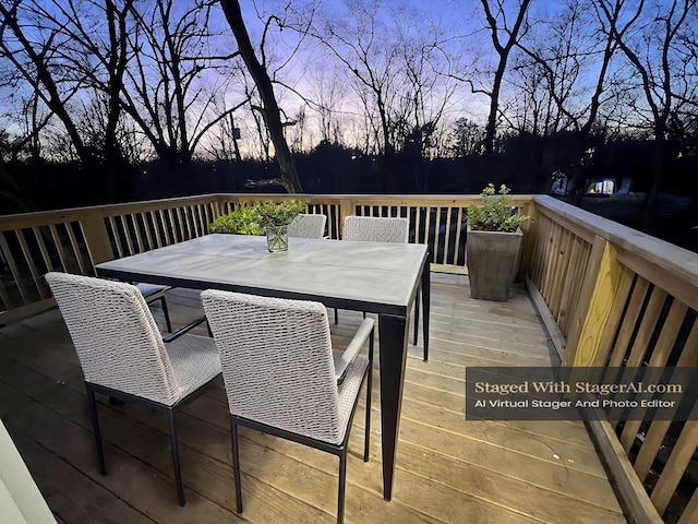 deck at dusk with outdoor dining space