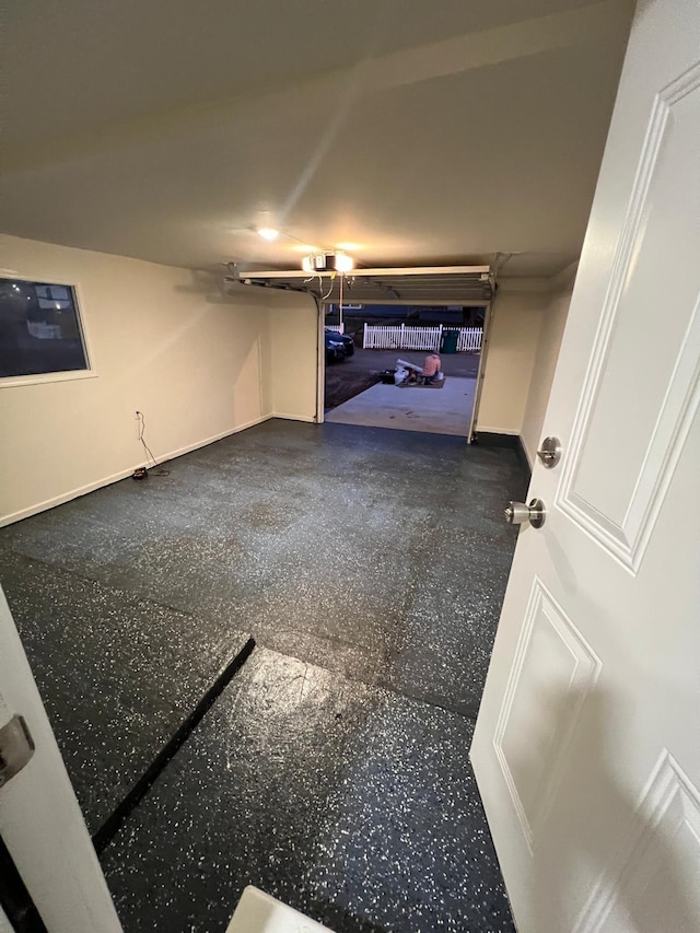 garage featuring baseboards and a garage door opener