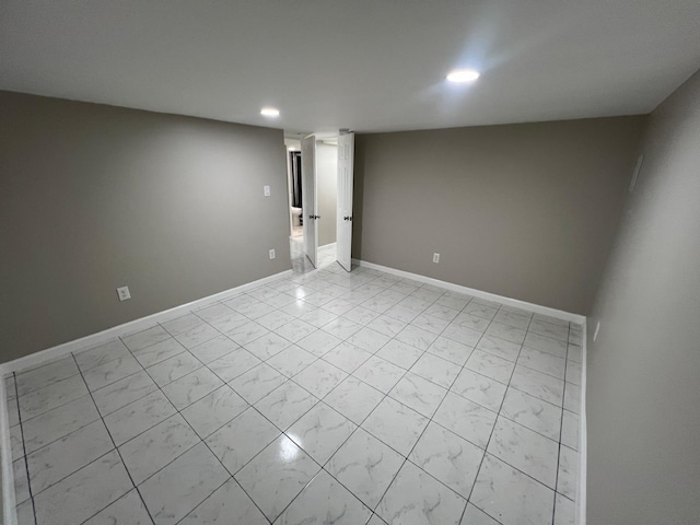 unfurnished room featuring recessed lighting, baseboards, and marble finish floor