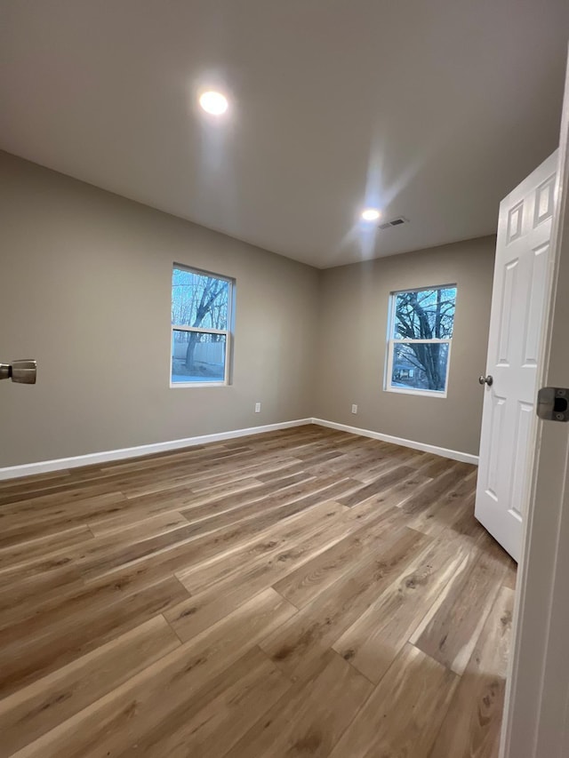 unfurnished bedroom featuring visible vents, recessed lighting, wood finished floors, and baseboards