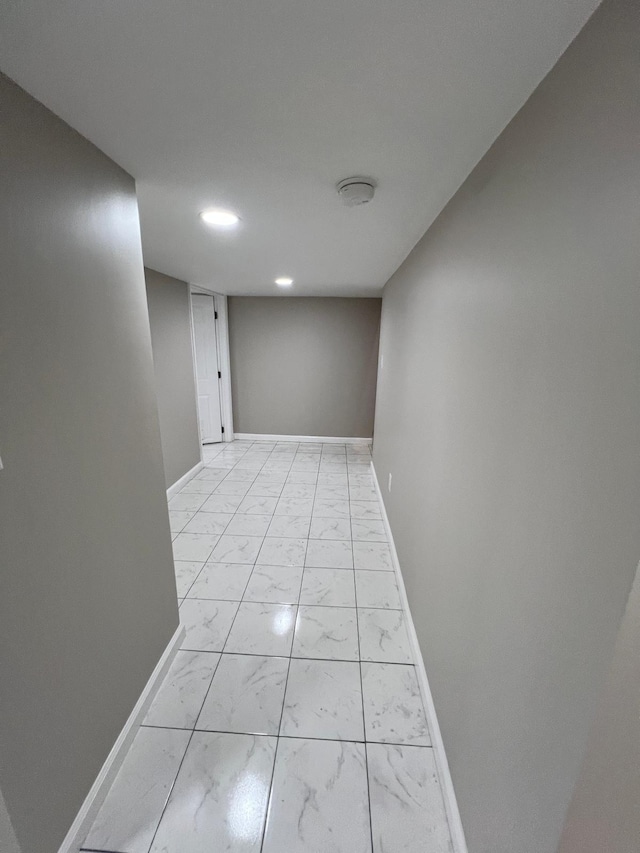 hall featuring baseboards and marble finish floor