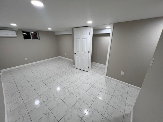 finished below grade area featuring recessed lighting, baseboards, marble finish floor, and a wall mounted AC