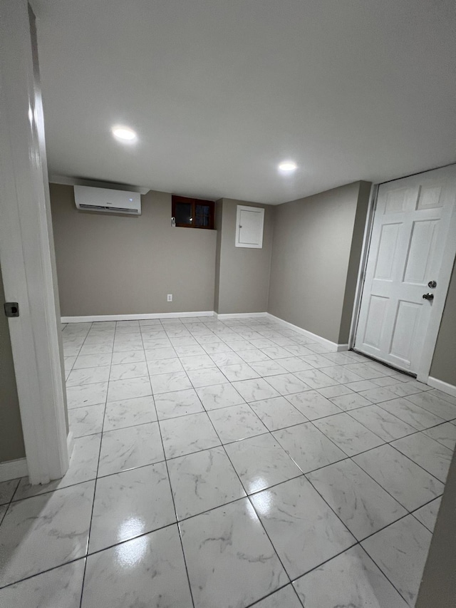 finished basement with recessed lighting, marble finish floor, a wall mounted AC, and baseboards