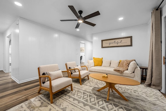 living room with crown molding and ceiling fan