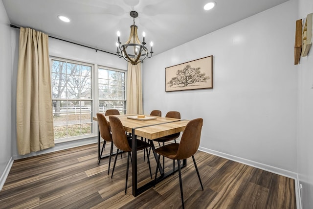 dining space with dark wood-type flooring and a chandelier