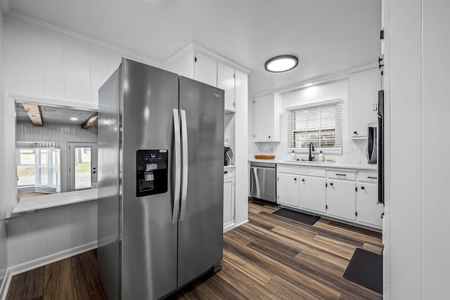 kitchen with stainless steel appliances, white cabinetry, sink, and dark hardwood / wood-style floors