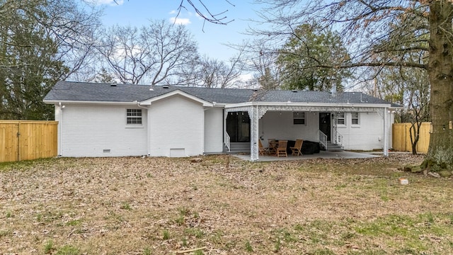 back of property featuring a yard and a patio