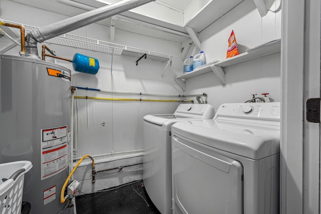 laundry area with washer and clothes dryer and gas water heater