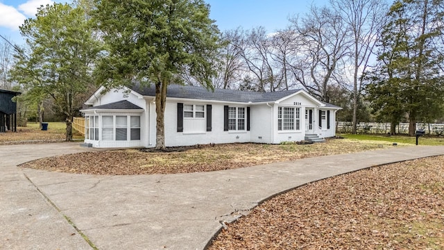 view of front of house with a sunroom