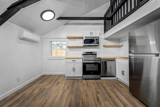 kitchen featuring wooden counters, an AC wall unit, white cabinets, stainless steel appliances, and backsplash