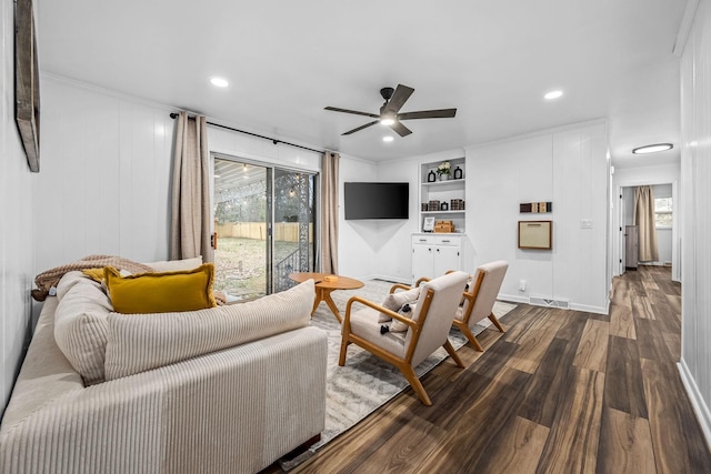 living room with ceiling fan, wood-type flooring, and built in features