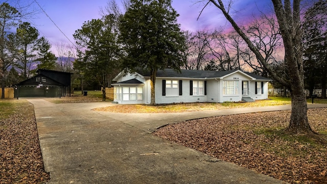 single story home featuring an outbuilding and a garage