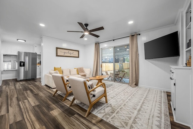 living room featuring crown molding, dark hardwood / wood-style floors, a wealth of natural light, and ceiling fan