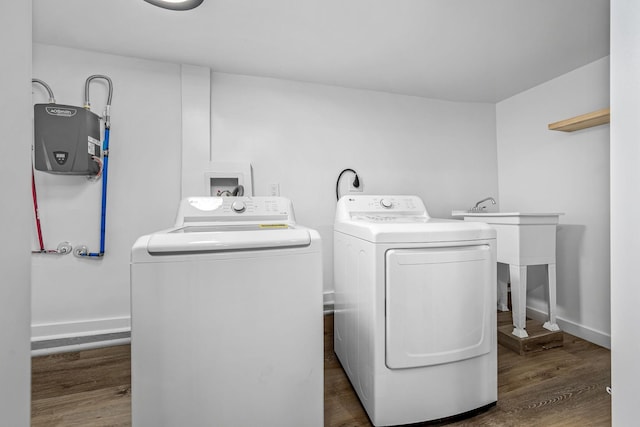 laundry room featuring separate washer and dryer and dark hardwood / wood-style flooring