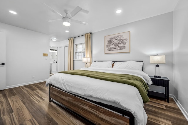 bedroom with ensuite bathroom, dark hardwood / wood-style floors, ceiling fan, and a closet