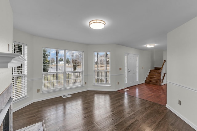 entryway featuring dark wood-style floors, baseboards, stairs, and visible vents