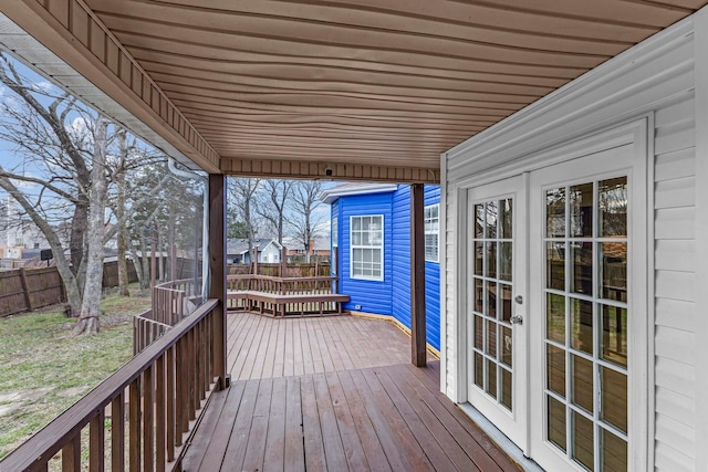 wooden terrace featuring fence and french doors