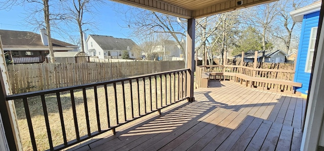 wooden terrace with fence private yard, a residential view, and a yard